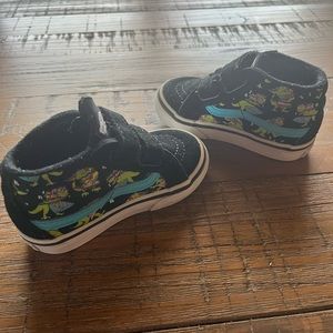 Vans off the wall sneakers with teal stripe and dinosaurs
